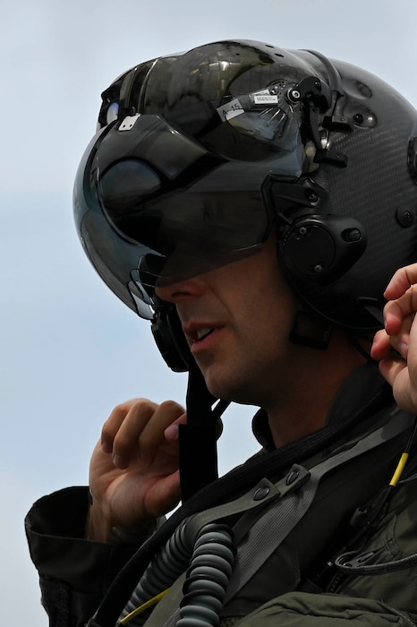 U.S. Air Force Lt. Col. Timothy “ Check” Six, top, 355th Mission Generation Force Element F-35A Lightning II pilot, puts on his helmet during exercise Resolute Force Pacific 25 in Guam, July 28, 2025.