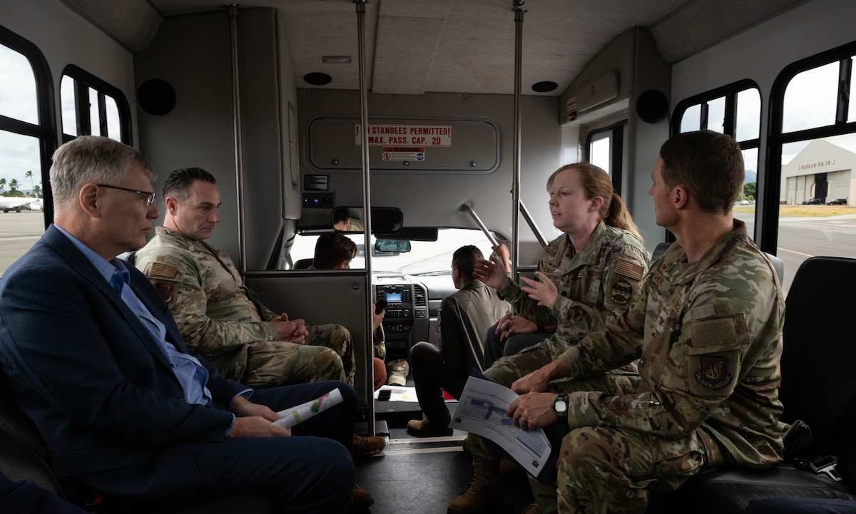 Secretary of the Air Force riding in s surrey with 3 members of Air Force leadership.