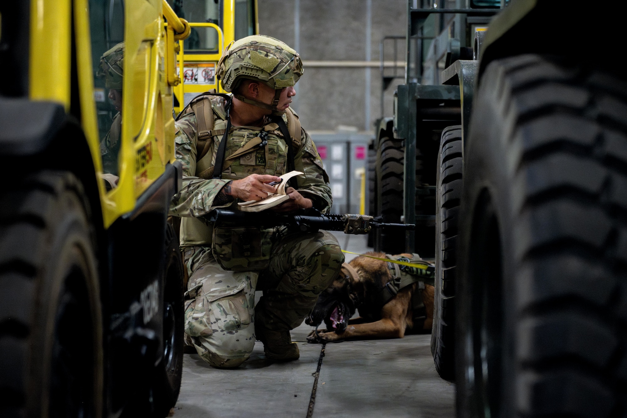 U.S. Air Force Staff Sgt. Kanejoshua Smoot, 35th Security Forces Squadron (SFS) military working dog (MWD) trainer, marks down the location of a simulated explosive device during MWD certification testing.