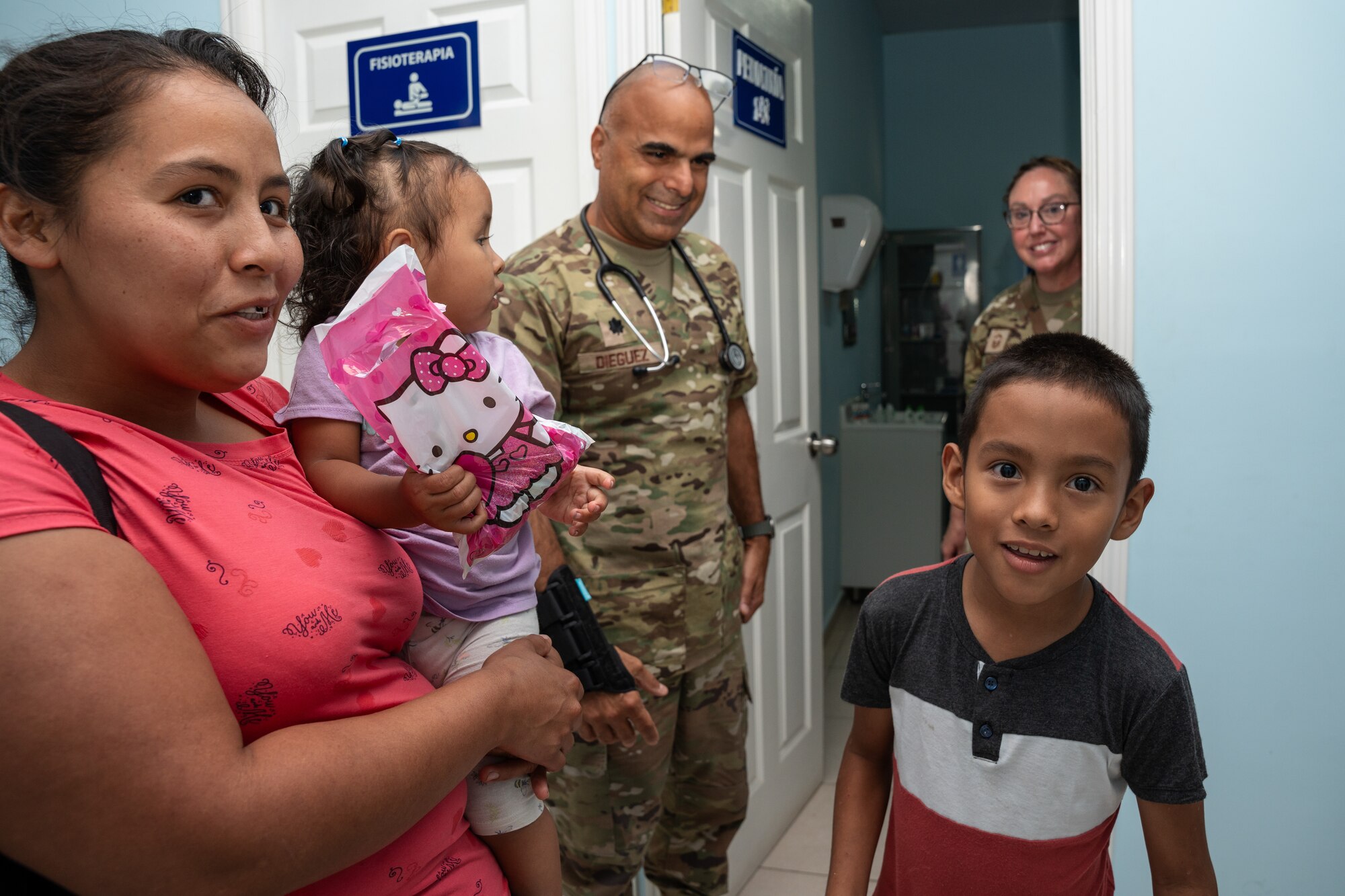 A Salvadoran family concludes a medical appointment during a community health event in Santa Ana, El Salvador, June 24, 2025. The event was a component of AMISTAD  2025, a mission that delivers direct patient care across several Latin American countries, builds readiness for U.S Air Force medics, and strengthens partnerships between U.S. forces and regional allies. (U.S. Air Force photo by Staff Sgt. Joshua Hastings)