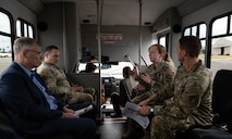 Secretary of the Air Force riding in s surrey with 3 members of Air Force leadership.