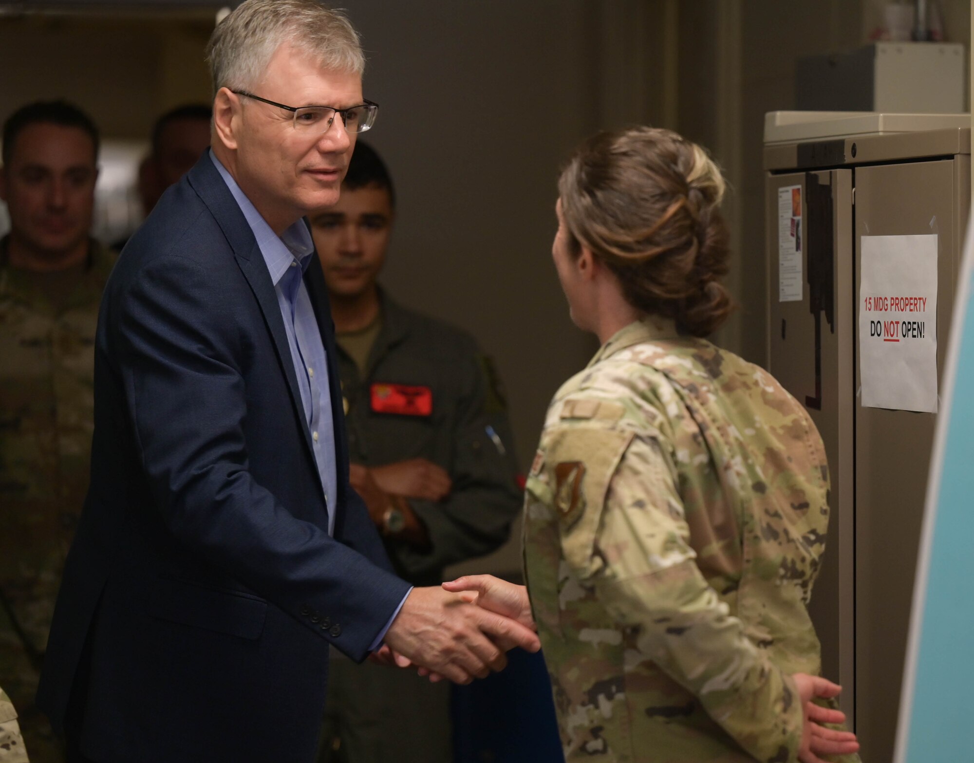 Secretary of the Air Force shaking hands with an Airman.