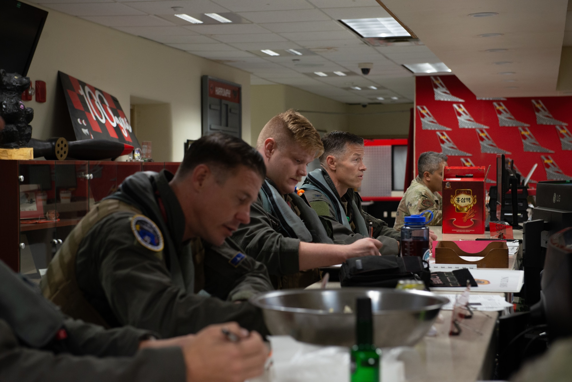 Pilots review flight plans before stepping to the aircraft.