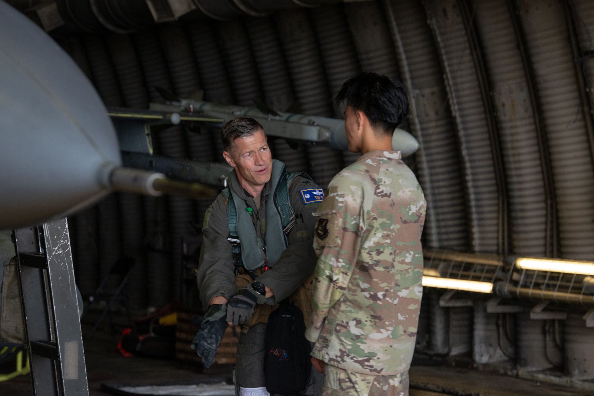 A pilot and maintainer converse before pre-flight checks.