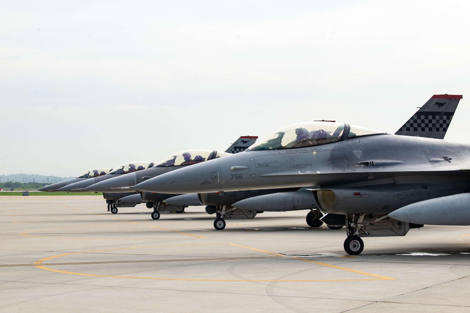F-16s line wait in line for final checks before takeoff.