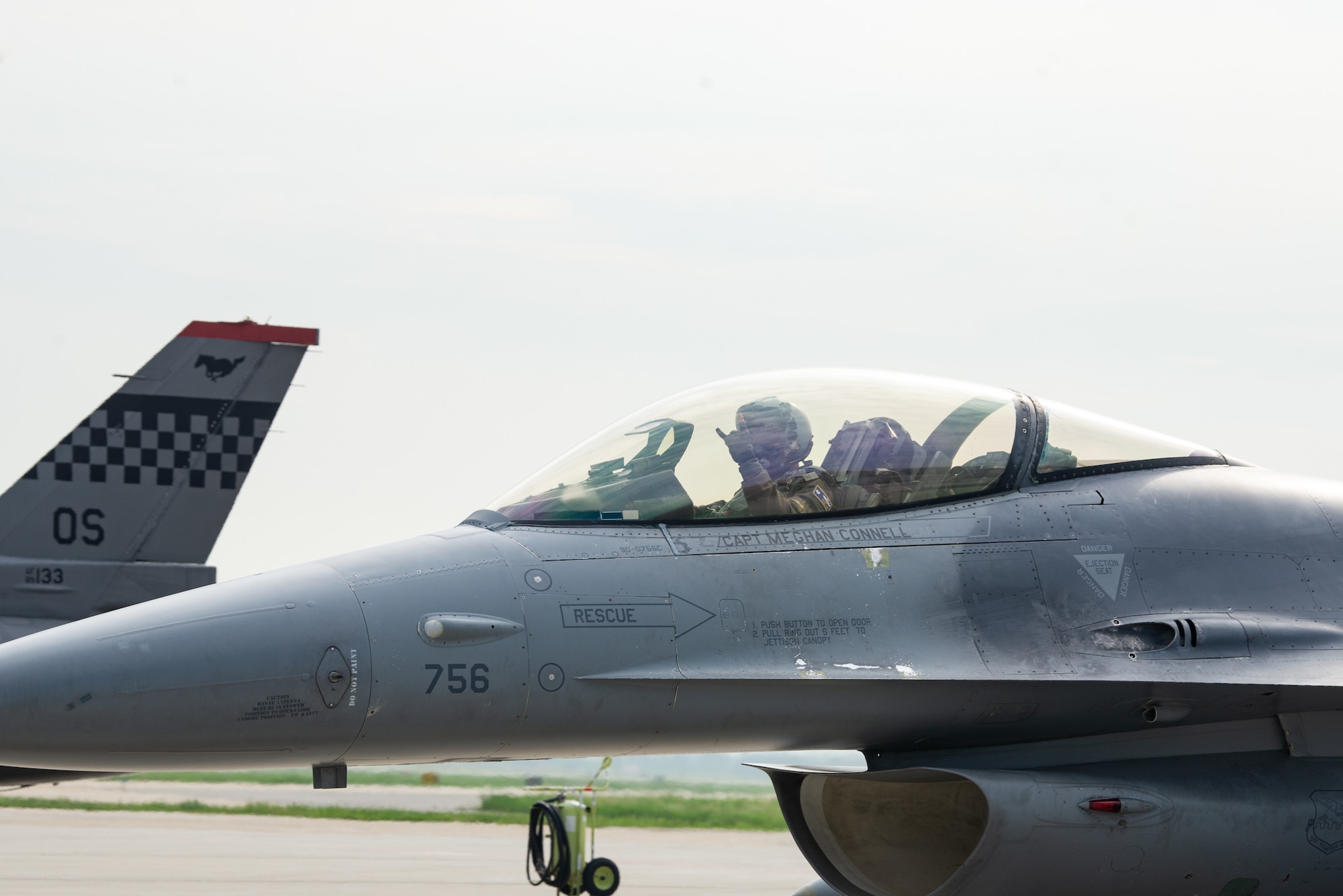 A pilot gives a squadron hand gesture.