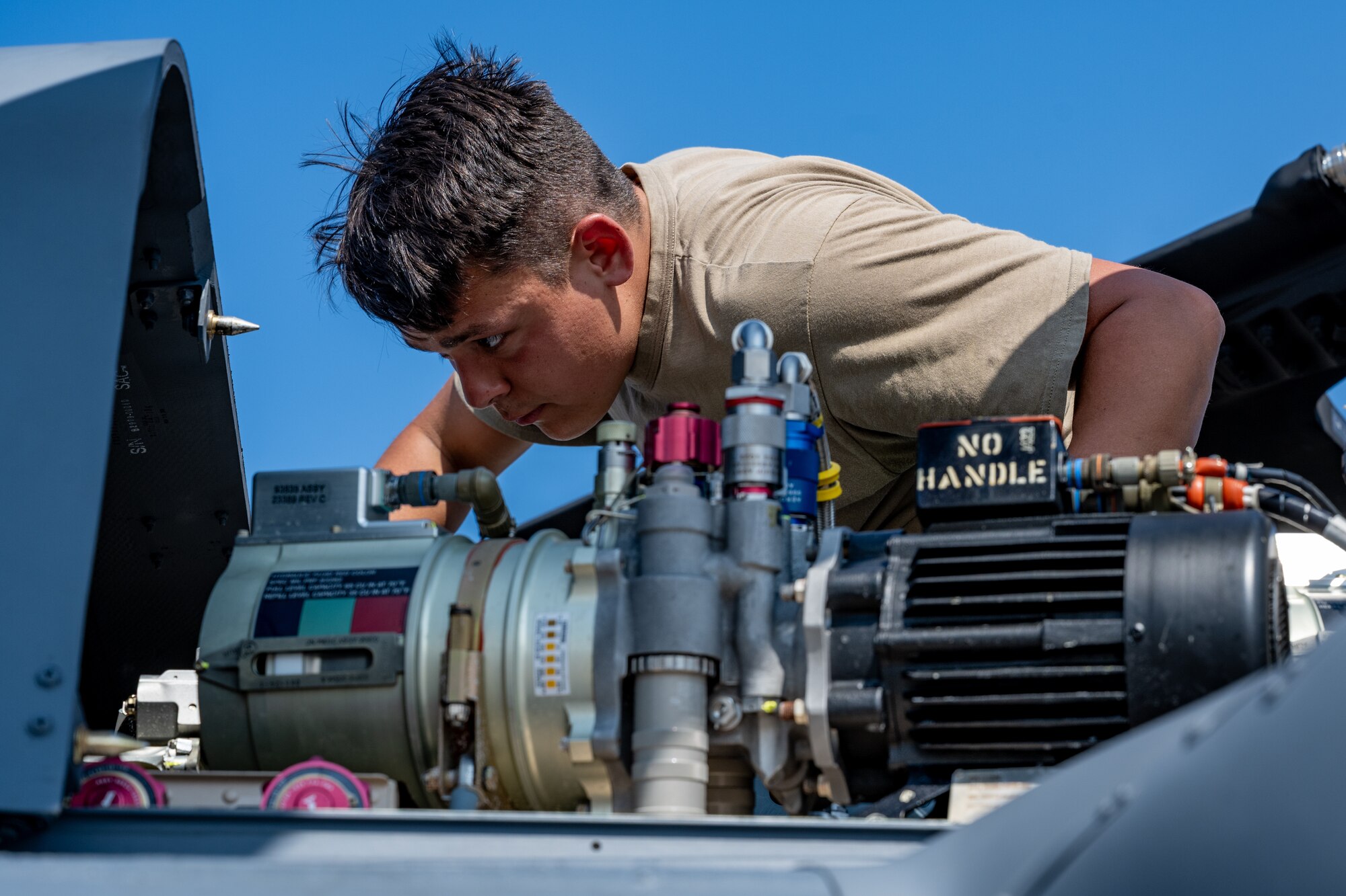 U.S. Air National Guard Staff Sgt. Jackson Carter, 106th Rescue Wing helicopter crew chief, performs an inspection on an HH-60W Jolly Green II during exercise Resolute Force Pacific (REFORPAC) 2025 at Misawa Air Base, Japan, July 16, 2025.