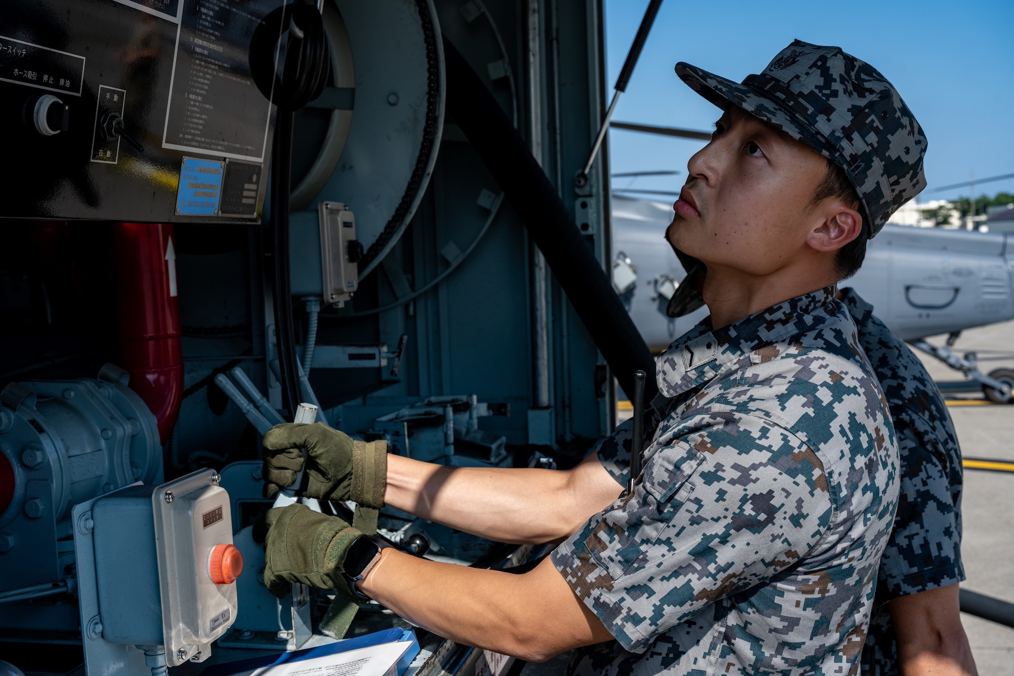 Japan Air Self-Defense Force Staff Sgt. Yuui Asanuma, 3rd Air Wing petroleum, oil, and lubricant technician, fuels an HH-60W Jolly Green II during exercise Resolute Force Pacific (REFORPAC) 2025 at Misawa Air Base, Japan, July 16, 2025