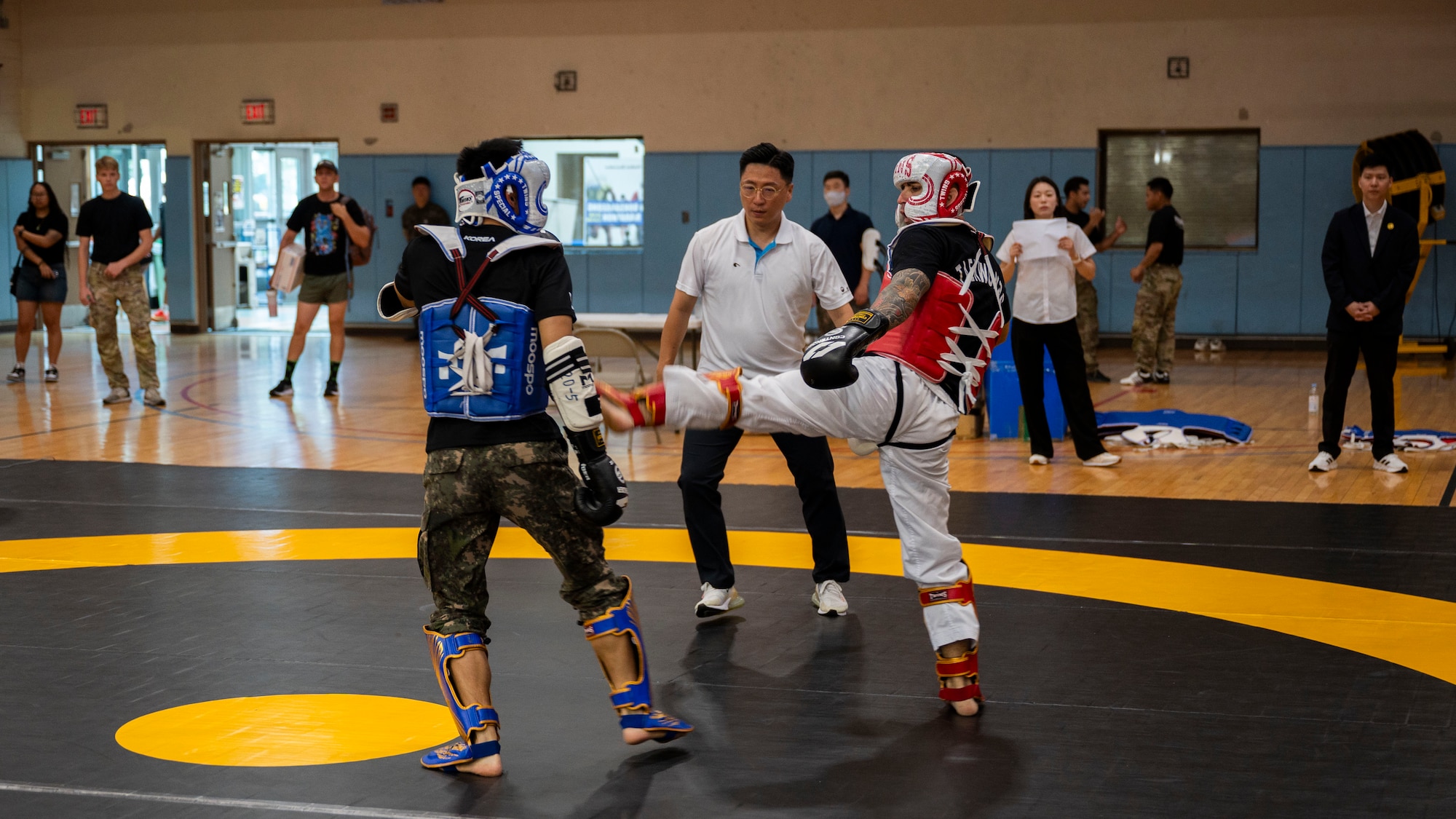U.S. Army Capt. Davon Stuart, right, 524th Military Intelligence Battalion officer in charge, lands a kick during the 2025 ROK-US Combat Taekwondo Exhibition at Osan Air Base, Republic of Korea, July 26, 2025. The exhibition allowed service members to experience the rich traditions of South Korea, reinforcing the strong diplomatic and military relationship between the two nations. (U.S. Air Force photo by Senior Airman Rome Bowermaster)