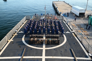 The crew of the Coast Guard Cutter Tahoma standing at parade rest on the flight deck at Port Everglades, Florida, July 29, 2025. The seized contraband was the result of an interdiction on June 24, 2025, approximately 120 miles northwest of Ecuador. (U.S. Coast Guard photo by Petty Officer 3rd Class Nicholas Strasburg)
