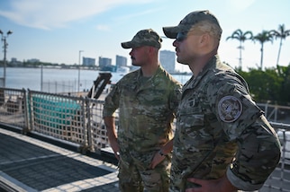 Coast Guard Tactical Law Enforcement Team - Pacific members watching over interdicted contraband at Port Everglades, Florida, July 29, 2025. Tactical law enforcement teams deploy aboard Coast Guard Cutters on drug interdiction missions to provide operational support. (U.S. Coast Guard photo by Petty Officer 3rd Class Nicholas Strasburg)