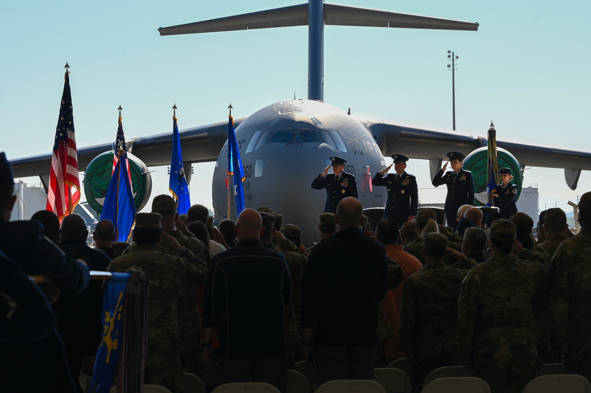From left, U.S. Air Force Maj. Gen. Charles Bolton, Eighteenth Air Force commander, Col. Sergio Anaya, outgoing 62d Airlift Wing commander, and Col. Jessica Regni, incoming 62d AW commander, render a salute to the flag during the presentation of colors at the 62d AW change of command ceremony at Joint Base Lewis-McChord, Washington, July 29, 2025.