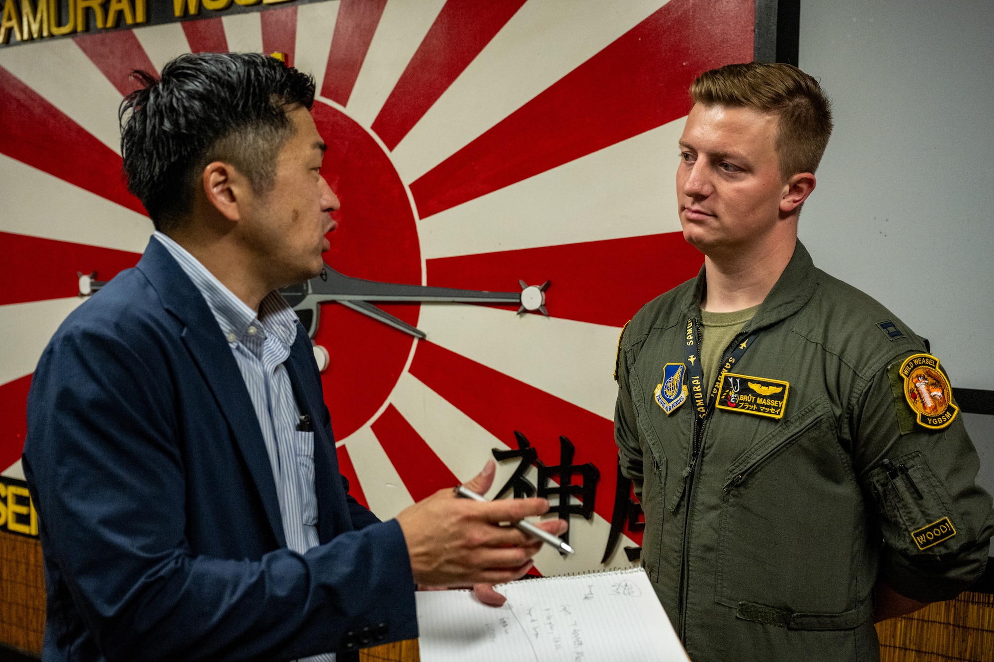 Yasuaki Todate, left, 35th Fighter Wing public affairs media advisor, briefs U.S. Air Force Capt. Tanner Massey, 14th Fighter Squadron pilot, before an interview with local media during exercise Resolute Force Pacific (REFORPAC) 2025 at Misawa Air Base