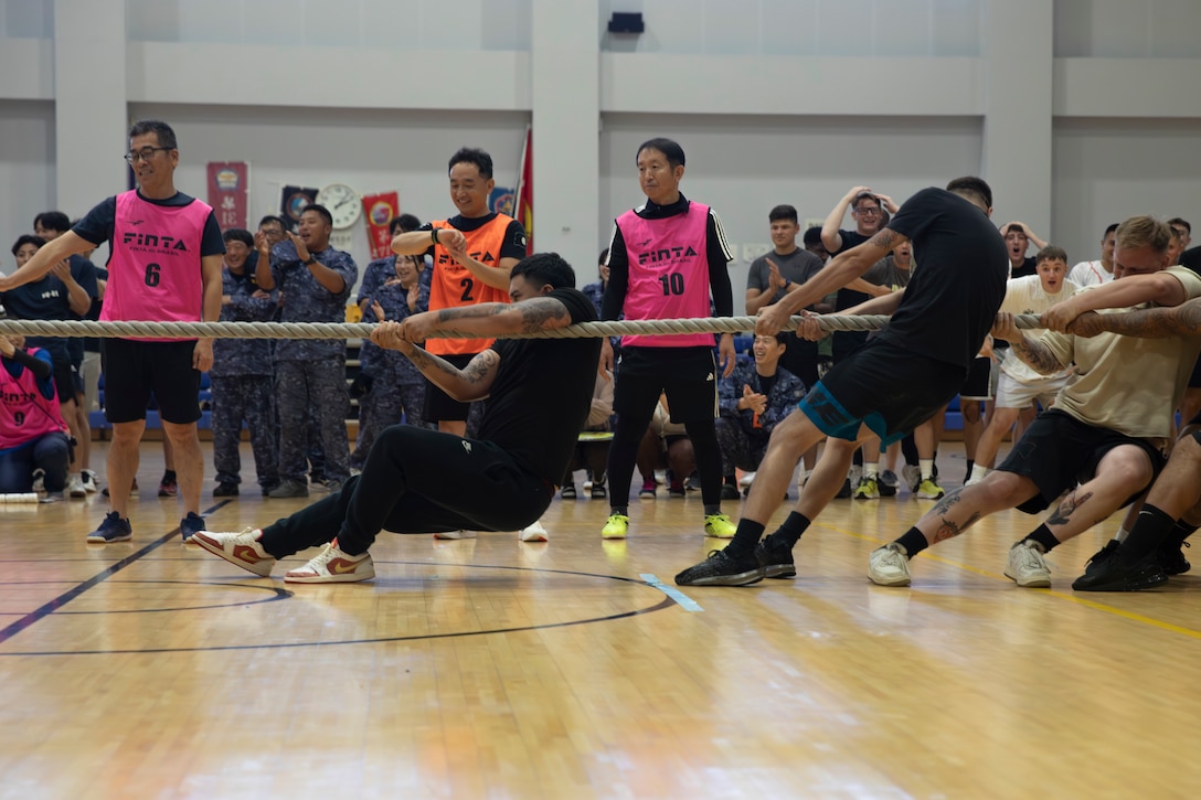 U.S. Navy Sailors with Headquarters and Headquarters Squadron, Marine Corps Air Station Iwakuni, compete in a tug of war during an Undokai event at MCAS Iwakuni, Japan, July 18, 2025. U.S. Marines, Sailors, and Japan Maritime Self-Defense Force members come together to participate in an Undokai, a traditional Japanese sports day event promoting physical fitness, to build camaraderie through friendly competition with events such as tug of war, relay races and push-ups further strengthening the U.S.-Japan alliance. (U.S. Marine Corps photo by Lance Cpl. Isaac De Leon)