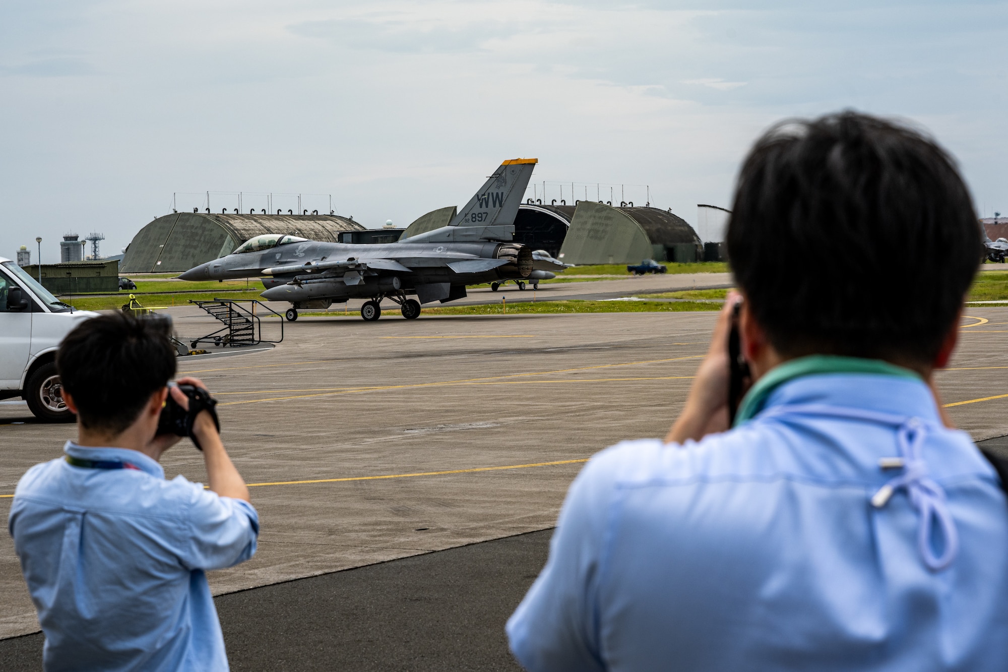 Members of the local media take photos of an F-16C Fighting Falcon assigned to the 14th Fighter Squadron taxiing onto the flightline during exercise Resolute Force Pacific (REFORPAC) 2025 at Misawa Air Base