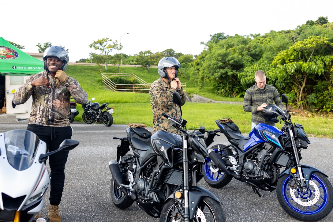 U.S. service members attending the Advanced Riders Course, put on their helmets during the Advanced Riders Course on Kadena Air Base, Okinawa, Japan, July 21, 2025. The course is mandatory for all Status of Forces Agreement personnel who operate any type of motorcycle. It enhances riders’ proficiency in basic techniques such as leaning, accelerating and braking, while emphasizing road safety through advanced riding instruction for both service members and civilians. (U.S. Marine Corps photo by Lance Cpl. Brody Robertson)