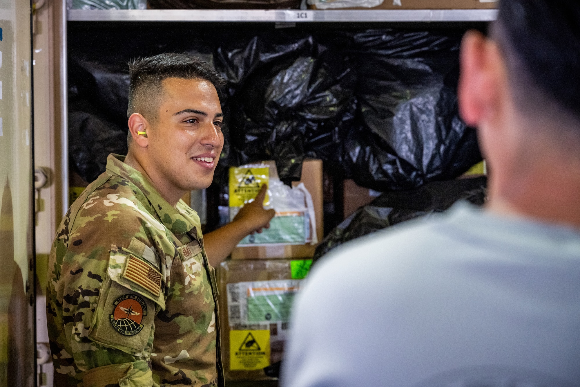 U.S. Air Force Staff Sgt. Noam Naiman, 730th Air Mobility Squadron lead joint inspector, guides Japan Air Self-Defense Force airmen through the cargo inspection process during exercise Resolute Force Pacific (REFORPAC) 2025
