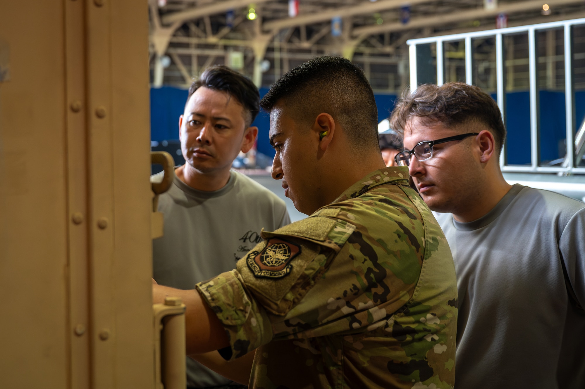 U.S. Air Force Staff Sgt. Noam Naiman, 730th Air Mobility Squadron lead joint inspector, guides Japan Air Self-Defense Force airmen through the cargo inspection process during a bilateral cargo loading training at Misawa Air Base, Japan, July 23, 2025.