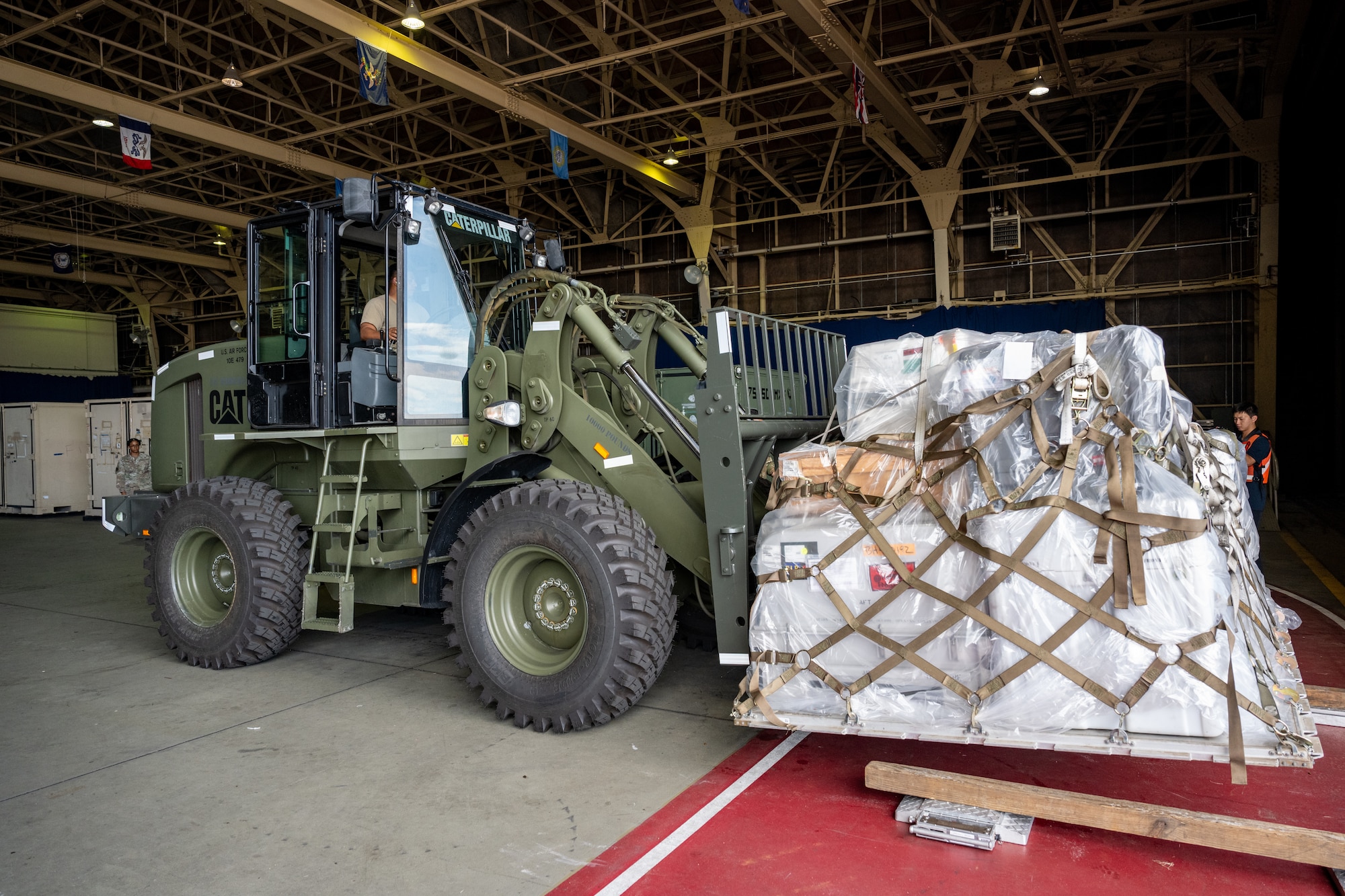 U.S. Air Force Tech. Sgt. Adrian Diaz, 35th Logistics Readiness Squadron air transportation function noncommissioned officer in charge, lowers cargo with a forklift during exercise Resolute Force Pacific (REFORPAC) 2025