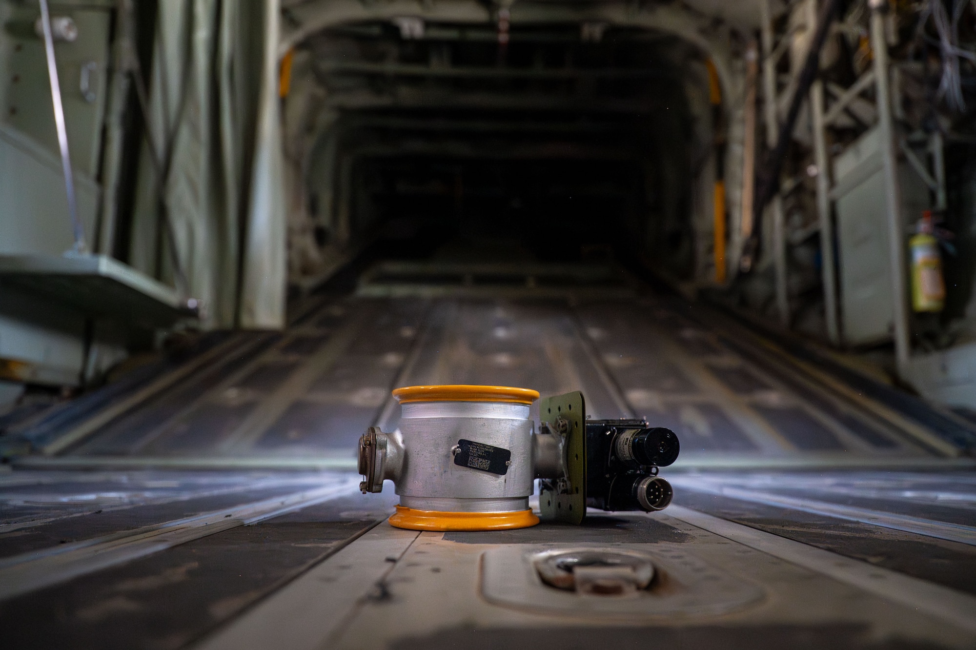 An aircraft part sits on the floor of the inside of an aircraft.