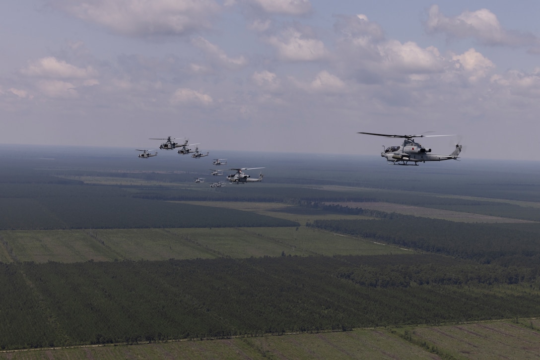 U.S. Marines with Marine Light Attack Helicopter Squadron (HMLA) 167, Marine Aircraft Group 29, 2nd Marine Aircraft Wing, fly AH-1Z Viper attack helicopters and UH-1Y Venom utility helicopters in formation near Marine Corps Air Station New River, July 25, 2025. HMLA-167 conducted surge operations to exercise their ability to launch and recover multiple divisions of aircraft concurrently. (U.S. Marine Corps Photo by Lance Cpl. Donovan Pimentel)