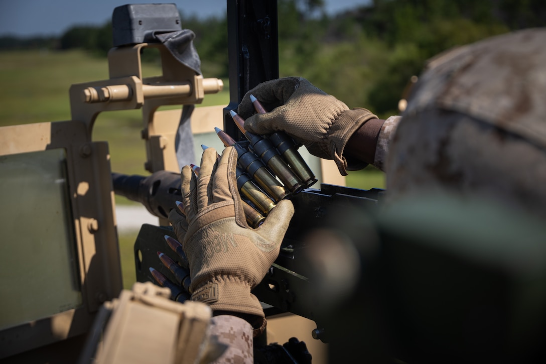 U.S. Marine Corps Cpl. Tavon Northern, a motor vehicle operator with 2nd Distribution Support Battalion, 2nd Marine Logistics Group, loads a .50 caliber machine gun on Marine Corps Base Camp Lejeune, North Carolina, July 27, 2025. Northern is a native of Albany, Georgia. U.S. Marines and Sailors conducted live-fire training with the M2 .50 caliber machine gun mounted on a Joint Light Tactical Vehicle, enhancing weapons proficiency, platform familiarity, and combat readiness.  (U.S. Marine Corps photo by Lance Cpl. Brady V. Hathaway)