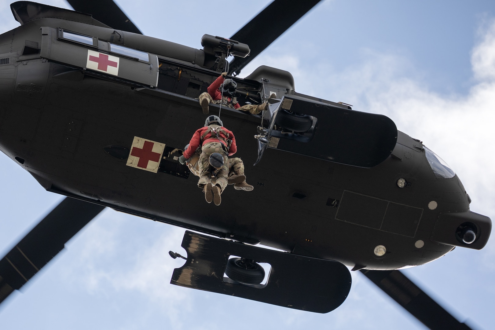 Alaska Army National Guard HH-60M MEDEVAC Black Hawk aviators conduct a hoist training demonstration.