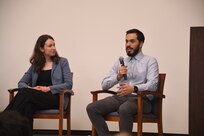 Maggie Stevens, (left), Ph.D., a research scientist in U.S. Naval Research Laboratory’s  (NRL) Electronics Science and Technology Division, listens as Harry Cole, (right), a returning Naval Research Enterprise Internship Program (NREIP) intern, shares his experiences during the “Pathways to Discovery” panel, July 17, 2025, in Washington, D.C. Cole spoke about the value of translatable skills and finding purpose through applied research.