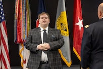 Matthew Crum sings the Star-Spangled Banner during a retirement ceremony for his father, Col. Ralph M. “Mac” Crum, U.S. Army Financial Management Command finance officer, at the Maj. Gen. Emmett J. Bean Federal Center in Indianapolis Nov. 26, 2024. Crum most recently served as USAFMCOM’s chief of staff and served four combat tours during his career. (U.S. Army photo by Brad Staggs)
