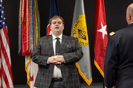 Matthew Crum sings the Star-Spangled Banner during a retirement ceremony for his father, Col. Ralph M. “Mac” Crum, U.S. Army Financial Management Command finance officer, at the Maj. Gen. Emmett J. Bean Federal Center in Indianapolis Nov. 26, 2024. Crum most recently served as USAFMCOM’s chief of staff and served four combat tours during his career. (U.S. Army photo by Brad Staggs)