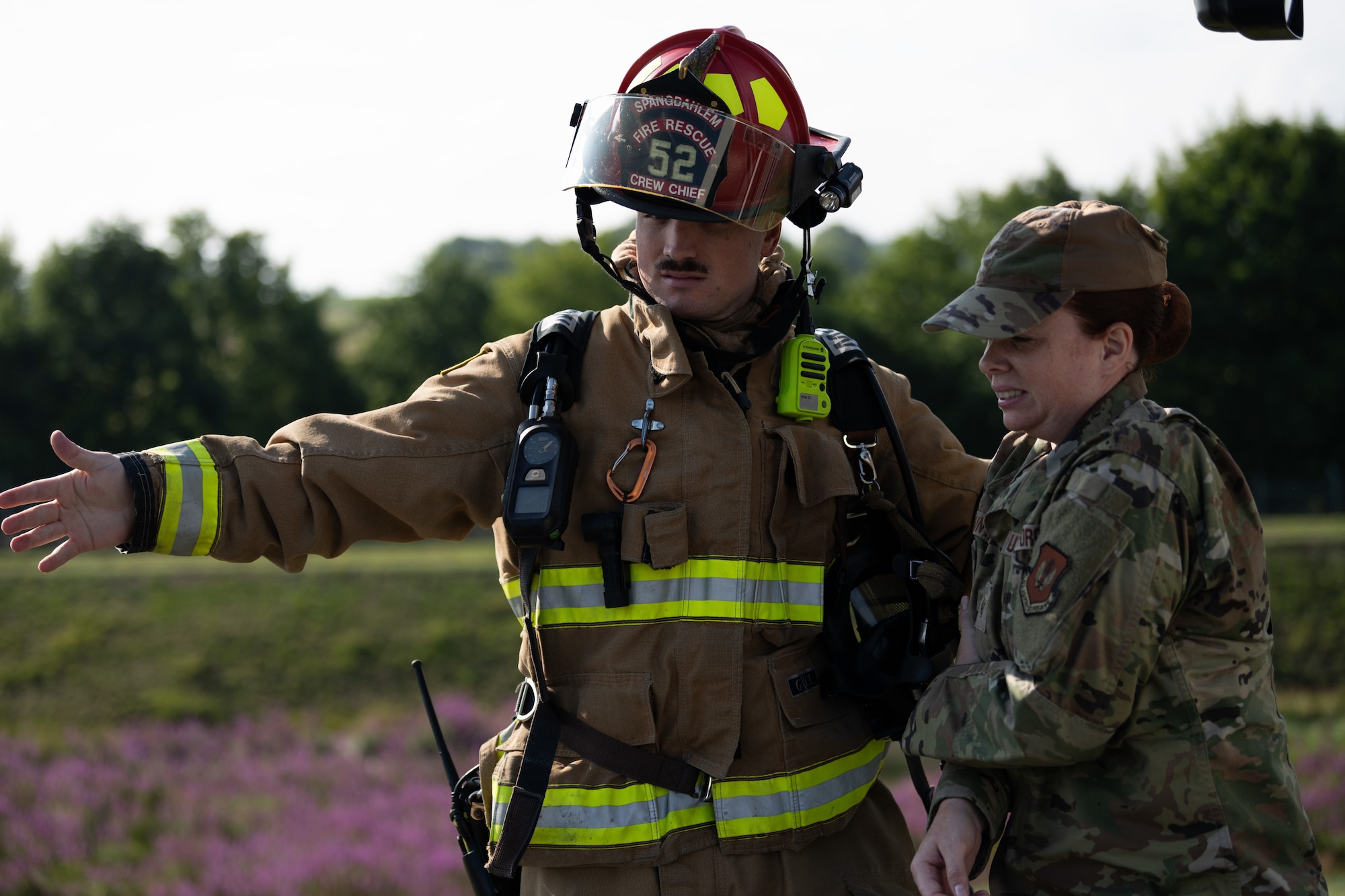 U.S. Air Force Staff Sgt. Jared Waddell, 52nd Civil Engineer Squadron fire protection specialist, left, escorts U.S. Air Force Tech. Sgt. Ashley Fountain, 52nd Medical Group education and training flight chief, to a casualty triage location during a Major Accident Response Exercise at Spangdahlem Air Base, Germany, July 30, 2025. During the exercise, simulated casualties were identified, evaluated and treated on-scene by emergency responders.