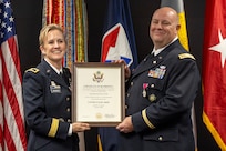 Brig. Gen. Paige M. Jennings, Office of Joint Chiefs of Staff Manpower and Personnel director, presents a certificate of retirement to Col. Ralph M. “Mac” Crum, U.S. Army Financial Management Command finance officer, during Crum’s retirement ceremony at the Maj. Gen. Emmett J. Bean Federal Center in Indianapolis Nov. 26, 2024. Crum most recently served as USAFMCOM’s chief of staff and served four combat tours during his career. (U.S. Army photo by Brad Staggs)