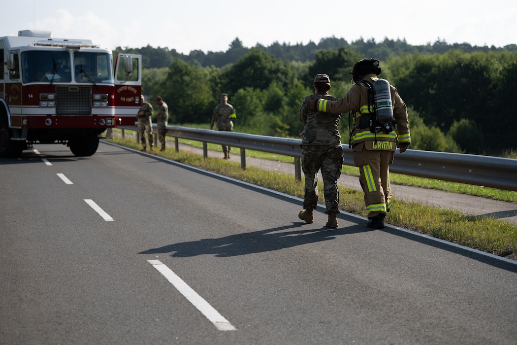 U.S. Air Force Senior Airman Daniel Griffin, 52nd Civil Engineer Squadron fire protection specialist, right, escorts U.S. Air Force Tech. Sgt. Ashley Fountain, 52nd Medical Group education and training flight chief, to a casualty collection point during a Major Accident Response Exercise at Spangdahlem Air Base, Germany, July 30, 2025. During the MARE, simulated casualties were assessed and treated by on-scene first responders.