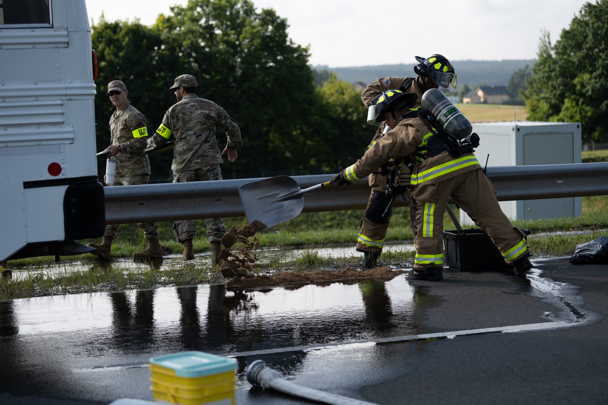 U.S. Air Force 52nd Civil Engineer Squadron fire protection Airmen, create a barrier to prevent the spread of a simulated fuel spill during a Major Accident Response Exercise on Spangdahlem Air Base, Germany, July 30, 2025. During the exercise, first responders attended to simulated casualties and damages as a means to evaluate their skills and readiness.