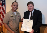 The U.S. Naval Research Laboratory (NRL) Commanding Officer Capt. Randy Cruz presents Scott Browning from NRL’s Signature Technology Office with the Department of the Navy Distinguished Civilian Service Award (DCSA), July 23, 2025, for his service as the technical director and senior advisor from 1991 through 2024. The DCSA is the highest Department of the Navy award for a civilian employee.