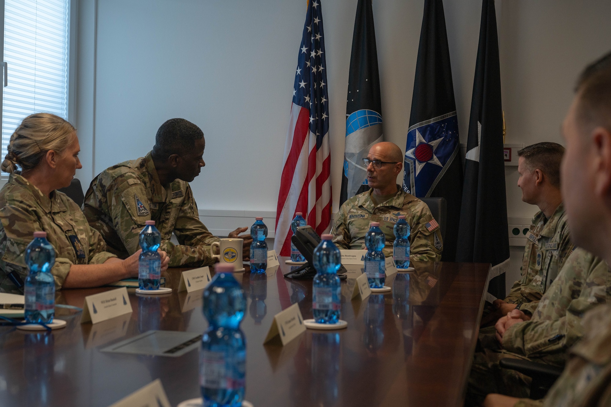 The Chief is at the head of a long table, the General listening in keenly, leaned forward