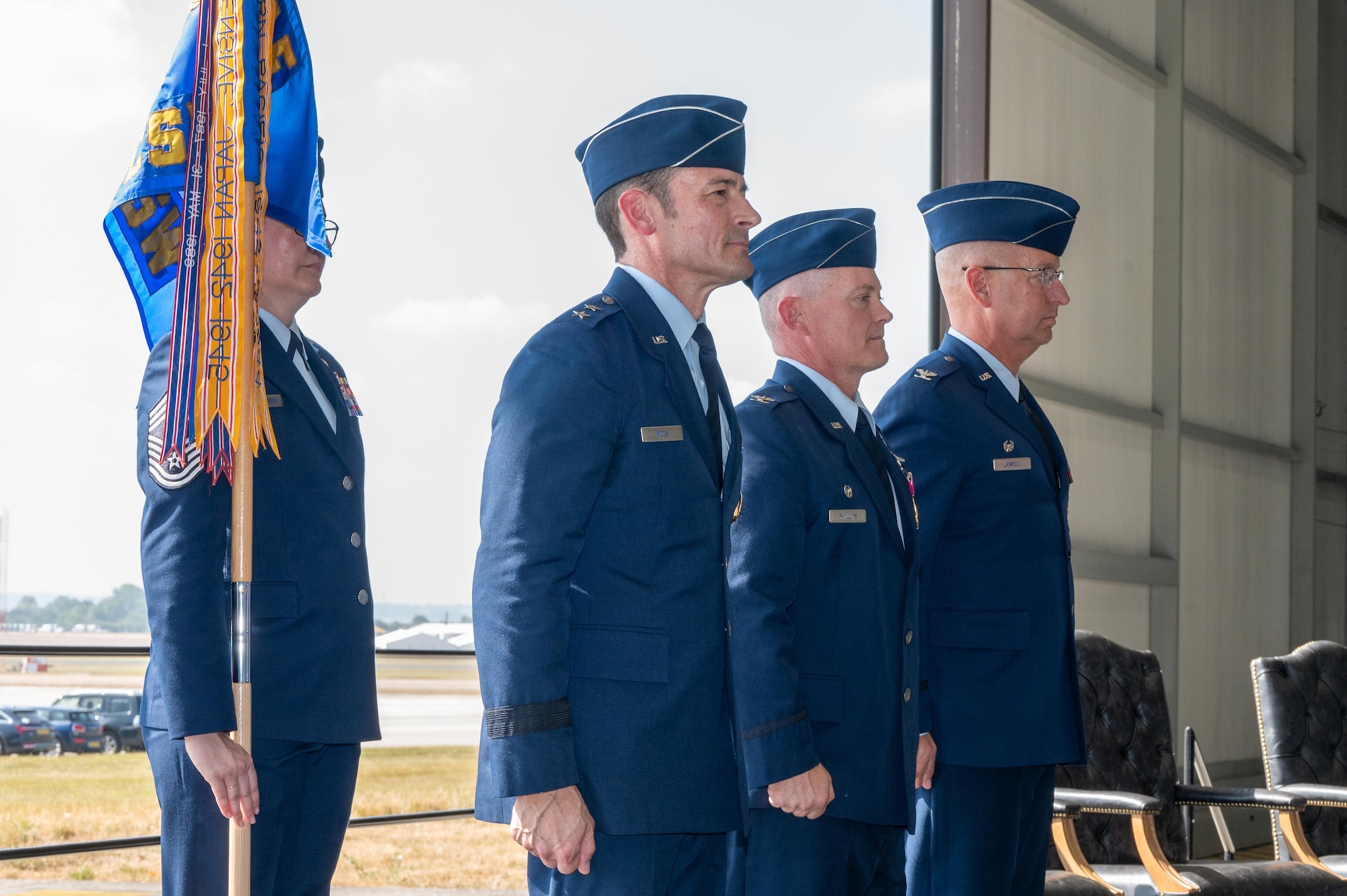 U.S. Air Force Maj. Gen. Paul Moga, Third Air Force commander, Col. D. Landon Phillips, 501st Combat Support Wing (CSW) outgoing commander, and Col. Michael J. Jewell, 501st Combat Support Wing (CSW) incoming commander, prepare to pass the guidon