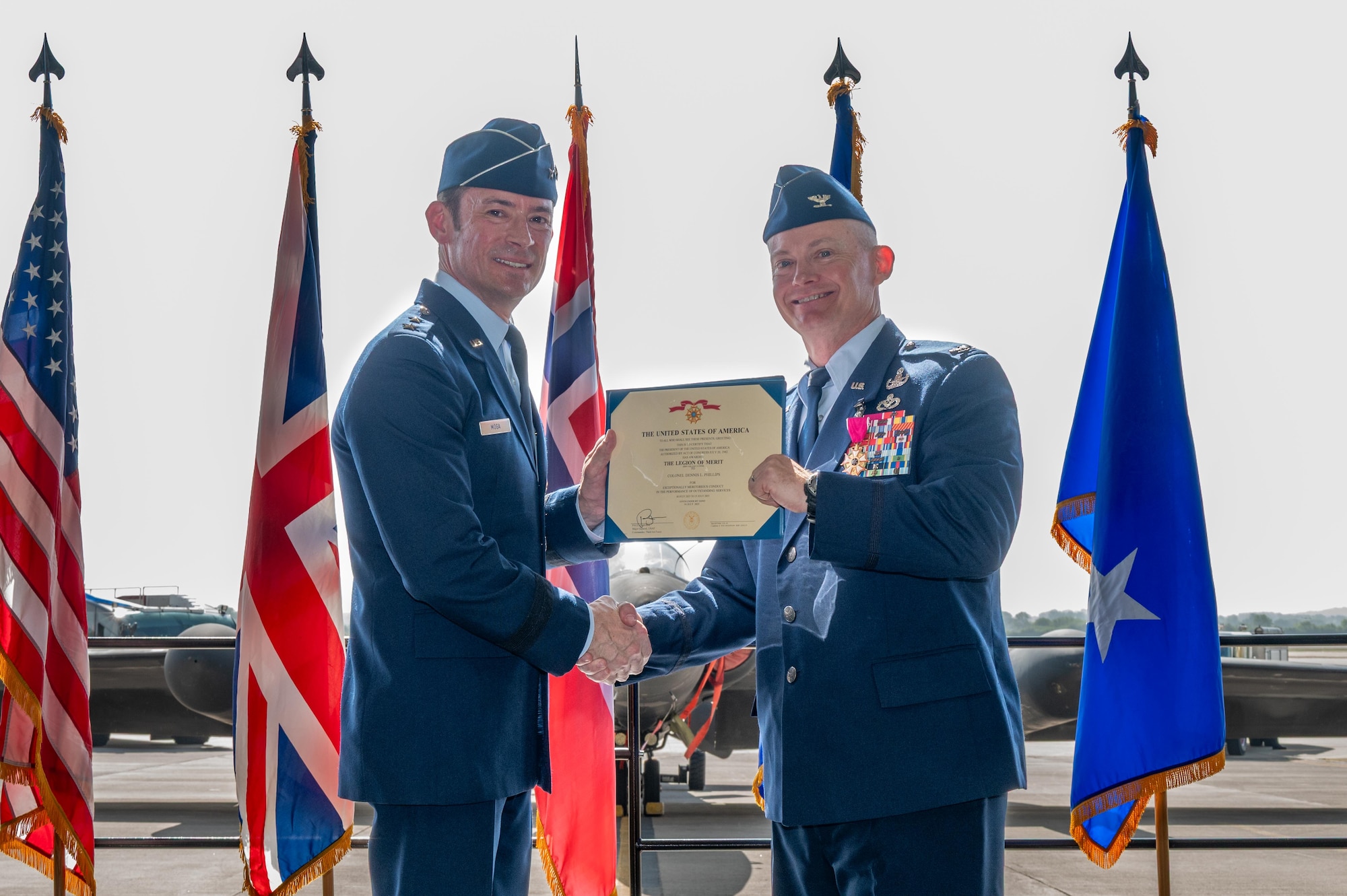 U.S. Air Force Col. D. Landon Phillips, 501st Combat Support Wing (CSW) outgoing commander, receives the Legion of Merit medal from Maj. Gen. Paul Moga