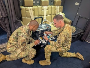 Image of two Airmen observing training equipment.
