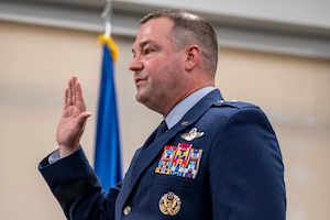 Airman in service dress takes oath