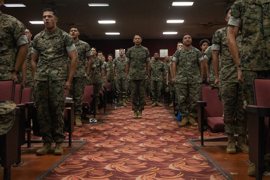 U.S. Marines sing the Marines’ Hymn alongside Sgt. Maj. Carlos A. Ruiz, the 20th Sergeant Major of the Marine Corps, during a town hall at the base theater at Marine Corps Base Hawaii (MCBH), June 24, 2025. During his visit, Ruiz met with leadership from MCBH, visited the College of Enlisted Military Education - Staff Noncommissioned Officer Academy, conducted a barracks walkthrough, toured the MCBH Individual Issue Facility (IIF), and spoke at an all-hands town hall. Ruiz visited MCBH to gain a better understanding of current operations. (U.S. Marine Corps photo by Lance Cpl. Tania Guerrero)
