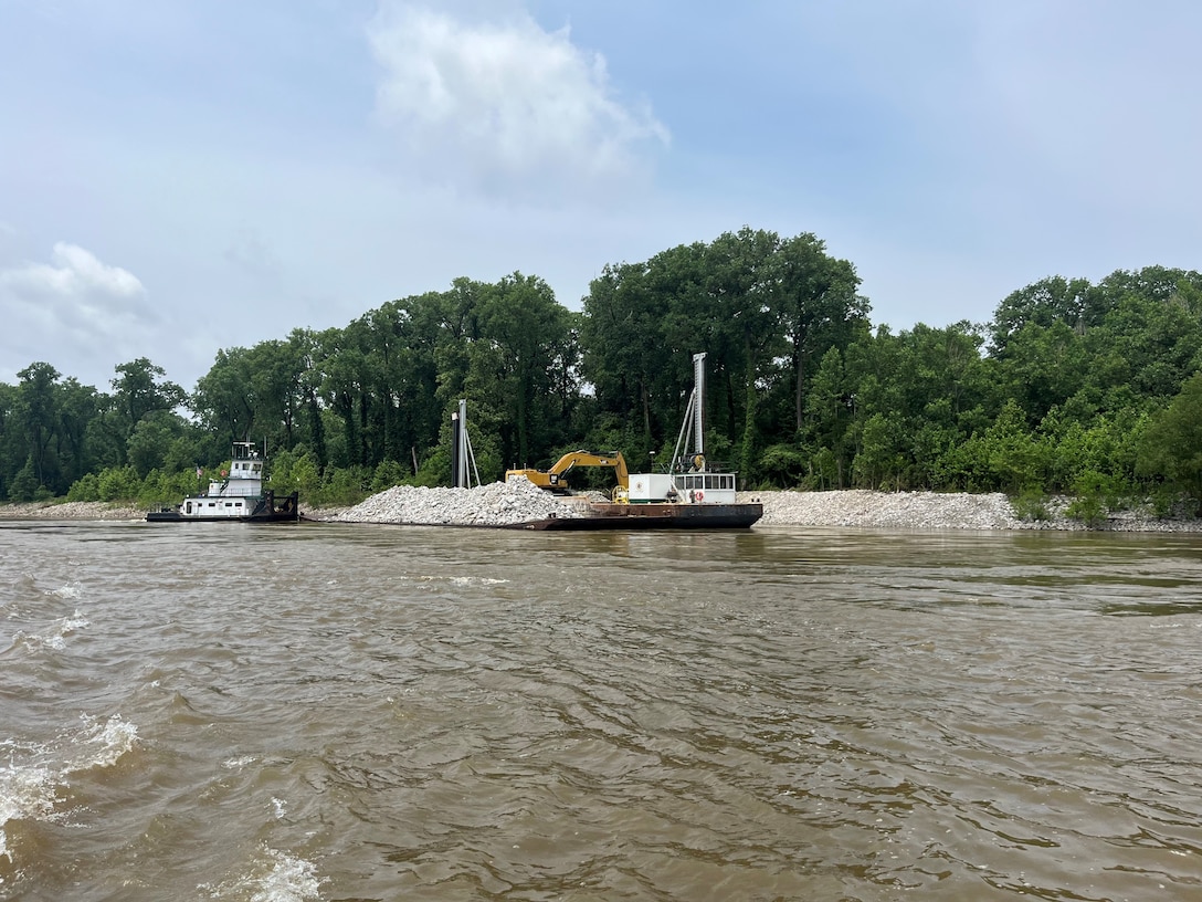 U.S. Army Corps of Engineers Memphis District Project Manager Zach Cook and Project Delivery Team members completed a revetment stone repairs project, July 12, in partnership with Commercial Towing Interests, represented by the Lower Mississippi River Committee, and contractor partner, Midwest Construction Company. 

The $1.5 million channel maintenance project placed 32,400 tons of Grade C Stone to repair two existing revetment locations. Revetment is placed against the banks of the river at locations where mainline levees are threatened or where unsatisfactory alignment and channel conditions are developing. 

Repairs will promote riverbank stability and to help maintain a safe and reliable navigation channel at River Miles 952L and 679.5R.