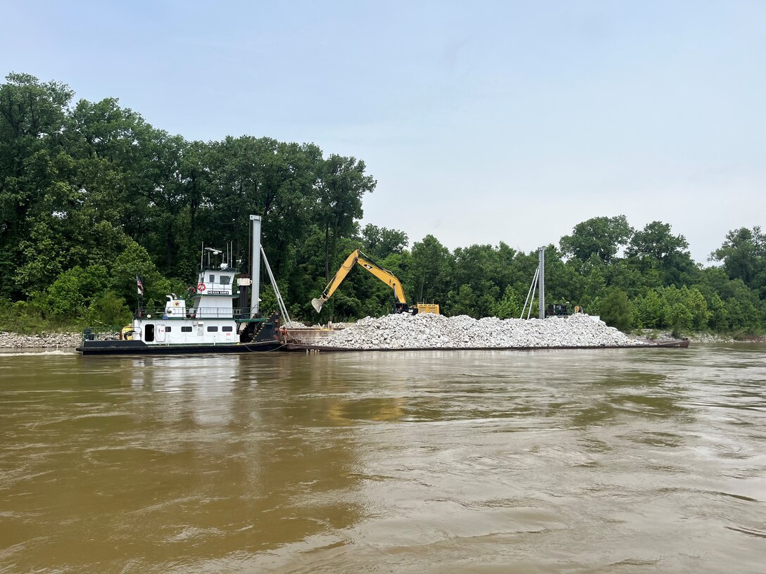 U.S. Army Corps of Engineers Memphis District Project Manager Zach Cook and Project Delivery Team members completed a revetment stone repairs project, July 12, in partnership with Commercial Towing Interests, represented by the Lower Mississippi River Committee, and contractor partner, Midwest Construction Company. 

The $1.5 million channel maintenance project placed 32,400 tons of Grade C Stone to repair two existing revetment locations. Revetment is placed against the banks of the river at locations where mainline levees are threatened or where unsatisfactory alignment and channel conditions are developing. 

Repairs will promote riverbank stability and to help maintain a safe and reliable navigation channel at River Miles 952L and 679.5R.