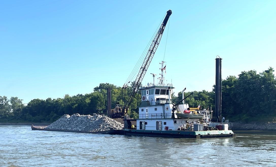 U.S. Army Corps of Engineers Memphis District Project Manager Zach Cook and Project Delivery Team members completed a revetment stone repairs project, July 12, in partnership with Commercial Towing Interests, represented by the Lower Mississippi River Committee, and contractor partner, Midwest Construction Company. 

The $1.5 million channel maintenance project placed 32,400 tons of Grade C Stone to repair two existing revetment locations. Revetment is placed against the banks of the river at locations where mainline levees are threatened or where unsatisfactory alignment and channel conditions are developing. 

Repairs will promote riverbank stability and to help maintain a safe and reliable navigation channel at River Miles 952L and 679.5R.