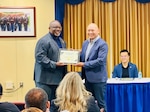 Certificate of appreciation is presented after an event.