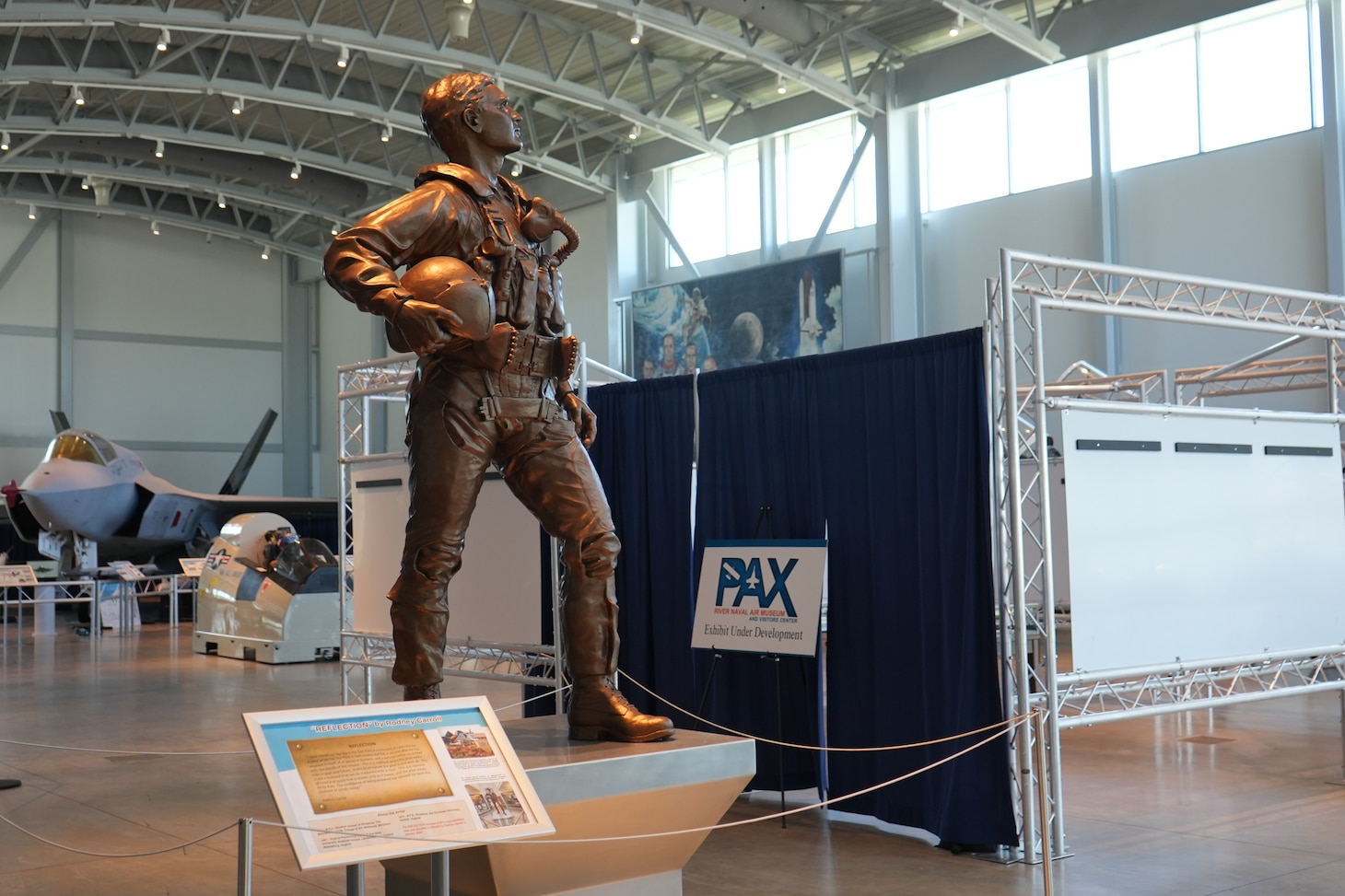 Curtains conceal the new U.S. Naval Test Pilot School exhibit at the Patuxent River Naval Air Museum in partnership with the Naval Air Warfare Center Aircraft Division. Featuring 80 years of history and achievements, the exhibit opens to the public on April 12, 2025. (U.S. Navy photo by Lindsay Wooleyhand)