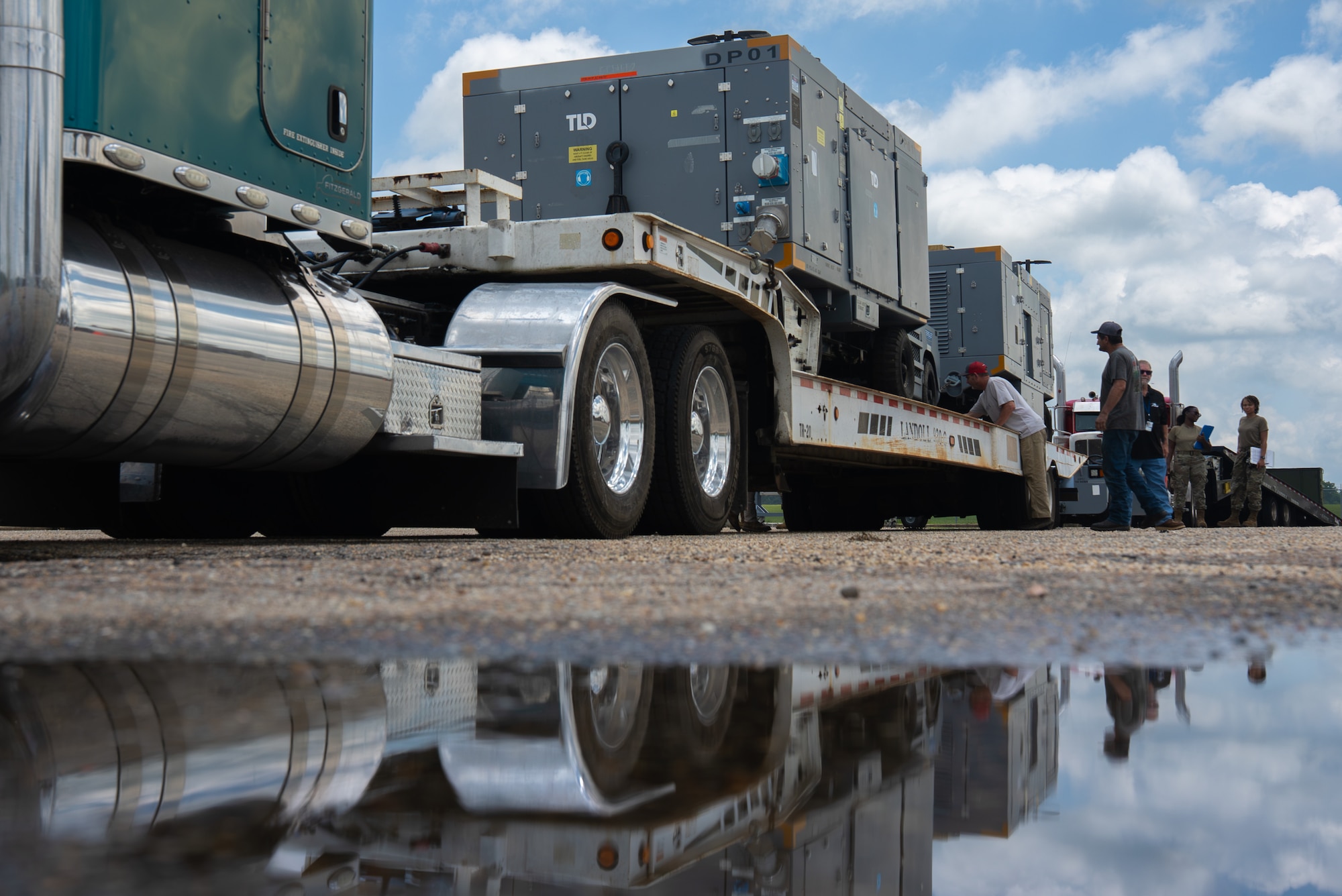 U.S. Airmen with the 187th Fighter Wing, Alabama Air National Guard, make final adjustments to cargo in a fully loaded semi-truck trailer during an agile logistics operation at Dannelly Field, Alabama, July 2, 2025. The operation is in support of the first-in-a-generation Department-Level Exercise series, a new way of conducting operations in a contested, dynamic environment to build capabilities making a stronger, more lethal deterrent force. The DLE series encompasses all branches of the Department of Defense, along with Allies and partners, employing more than 400 Joint and coalition aircraft and more than 12,000 members at more than 50 locations across 3,000 miles. (U.S. Air National Guard photo by Airman 1st Class Andre Bordlee)