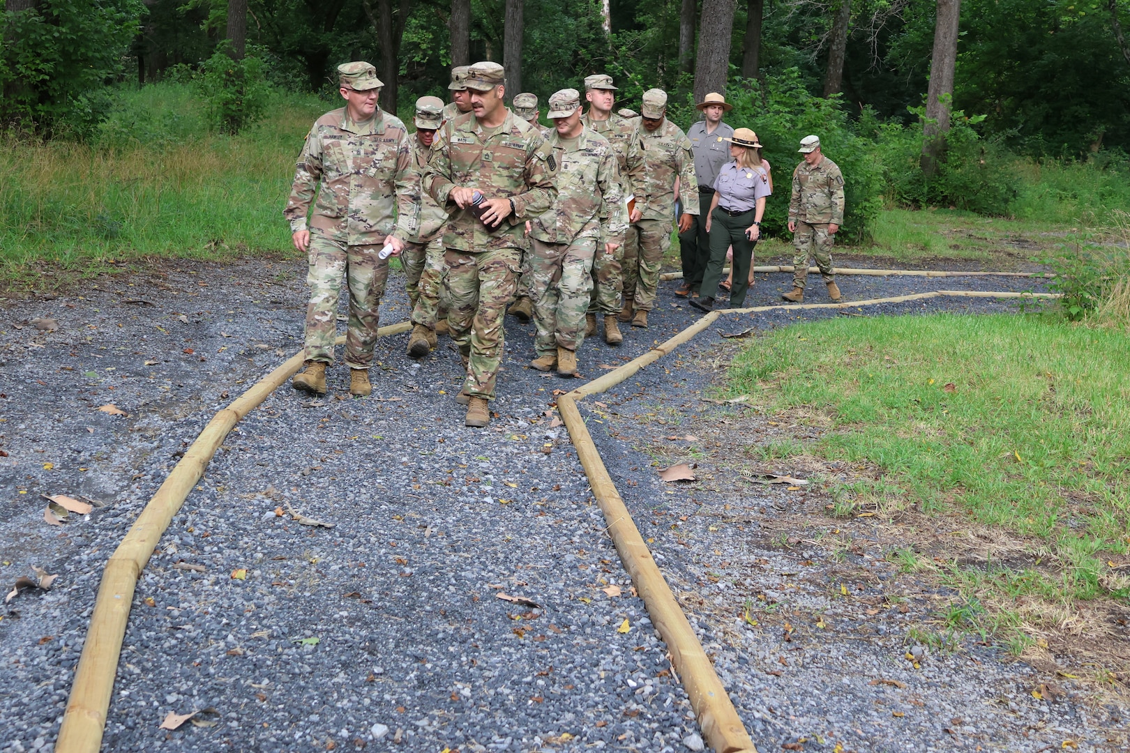 Virginia National Guard leaders from the state, brigade and battalion level visit Soldiers assigned to the Cedar Bluff-based 1033rd Engineer Support Company, 276th Engineer Battalion, 329th Regional Support Group constructing a parking area and walking trail July 21, 2025, at the Cedar Creek & Belle Grove National Historical Park in Middletown, Virginia. The leaders met with U.S. National Park rangers, learned more about the project and the park, thanked Soldiers for their service and presented challenge coins to recognize outstanding duty performance. The project is part of the Innovative Readiness Training program where engineers put their military skills to work on community service projects approved by National Guard Bureau.