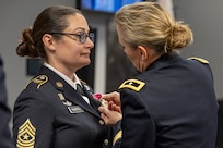 Brig. Gen. Paige M. Jennings, Office of Joint Chiefs of Staff Manpower and Personnel director, presents a Legion of Merit to Sgt. Maj. Julie D. Harris, U.S. Army Financial Management Command Operations senior enlisted advisor, during Harris’ retirement ceremony at the Maj. Gen. Emmett J. Bean Federal Center in Indianapolis Nov. 25, 2024. Harris retired from the U.S. Army after more than 22 years of service. (U.S. Army photo by Mark R. W. Orders-Woempner)
