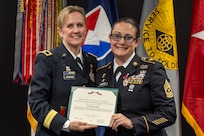 Brig. Gen. Paige M. Jennings, Office of Joint Chiefs of Staff Manpower and Personnel director, presents a Legion of Merit to Sgt. Maj. Julie D. Harris, U.S. Army Financial Management Command Operations senior enlisted advisor, during Harris’ retirement ceremony at the Maj. Gen. Emmett J. Bean Federal Center in Indianapolis Nov. 25, 2024. Harris retired from the U.S. Army after more than 22 years of service. (U.S. Army photo by Mark R. W. Orders-Woempner)